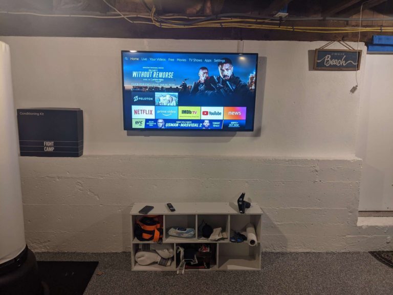 TV mounted on a basement cement wall.