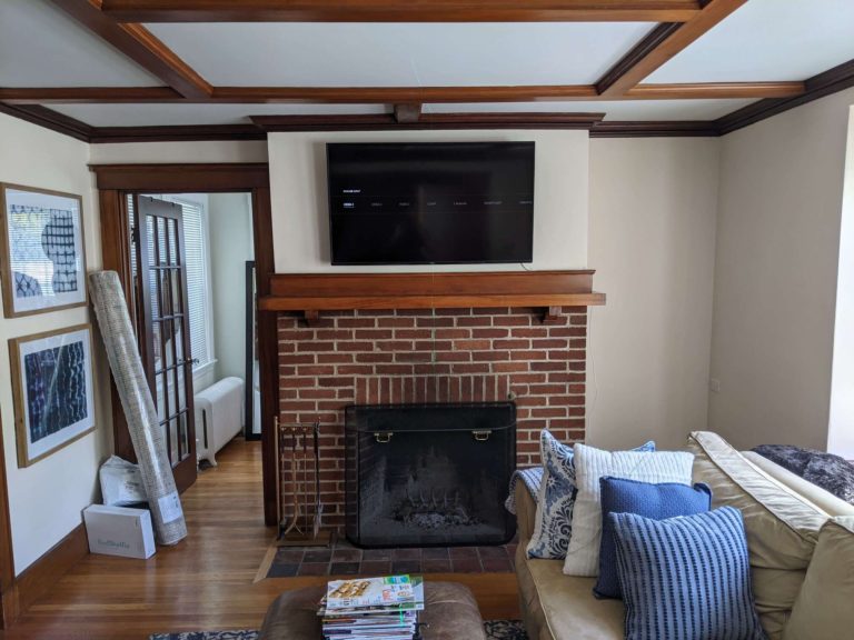 TV mounted above living room fireplace.