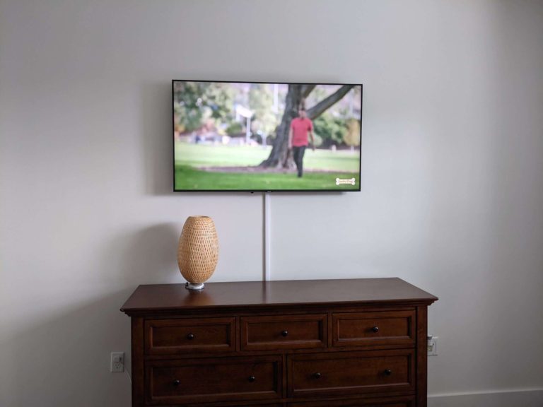 TV mounted on drywall with wires masked.