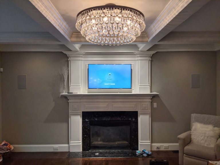 TV mounted above a fireplace inside a mansion.